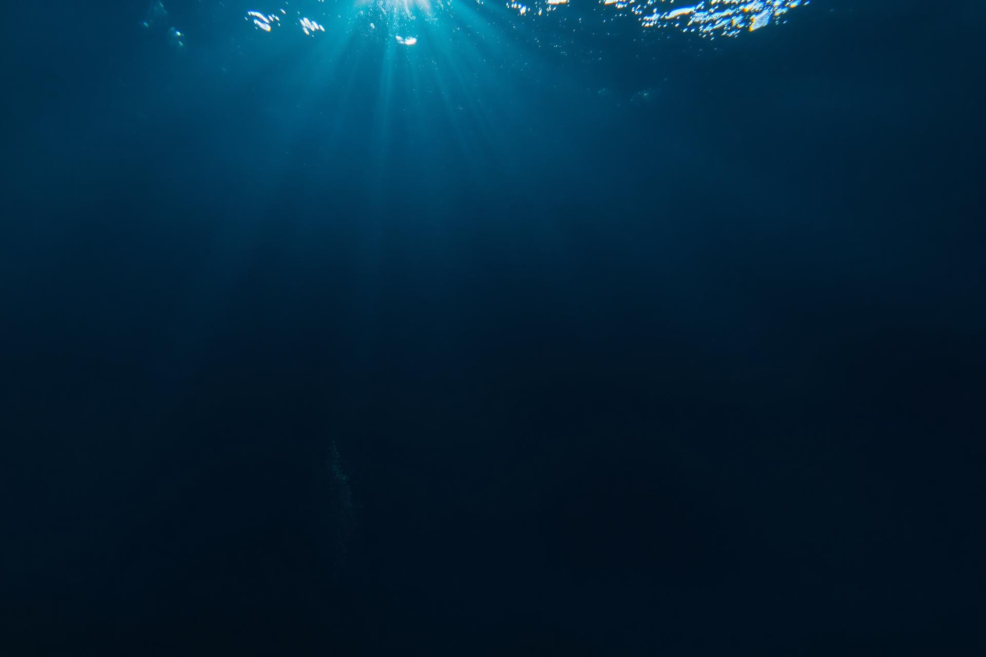 Sunlight piercing through deep ocean water
